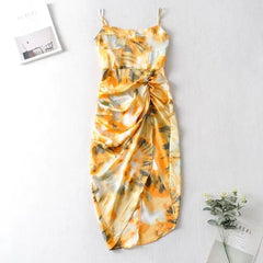  Golden Atelier tie-dye sundress with a relaxed silhouette and spaghetti straps. The dress features a colorful tie-dye pattern and is modeled on a woman in a summery setting. Yellow 3