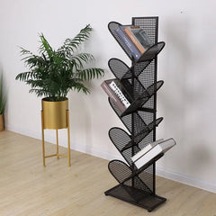 Golden Atelier tree-shaped bookshelf made of black metal grid with multiple shelves for displaying and storing books in a living room setting. Black