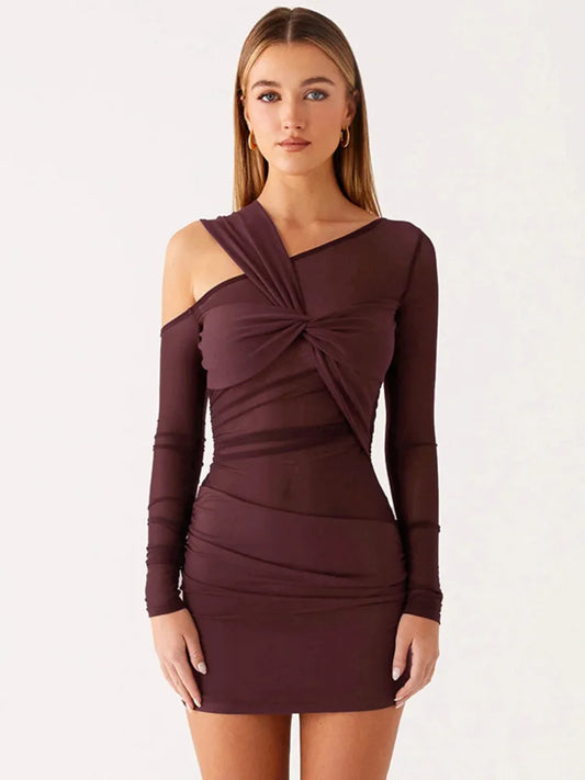 Woman wearing a burgundy dress with long sleeves and a knot detail on a white background