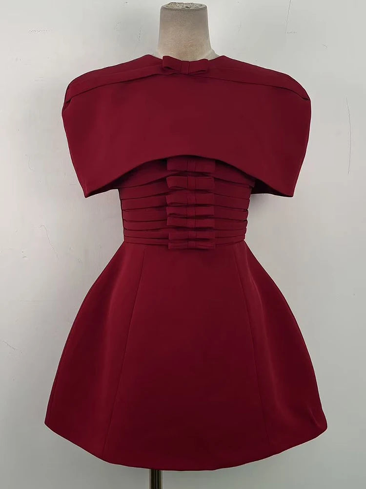 Three-quarter view highlighting the A-line mini skirt flare and smooth fabric structure, styled for a formal party look with minimal accessories.