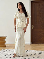 The full length of the pleated A-line skirt set, showing its elegant movement.