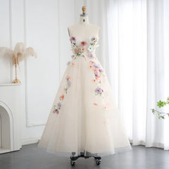 A close-up of the delicate floral appliqués and embroidery on the tulle fabric.