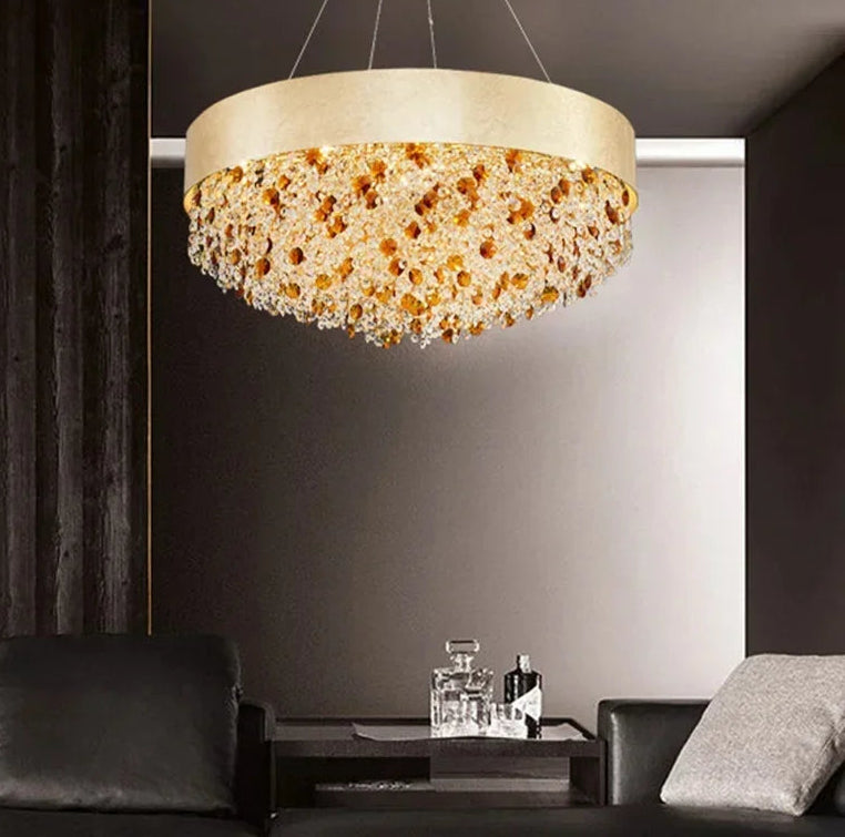 Amber crystal ring chandelier suspended in a luxury dining room