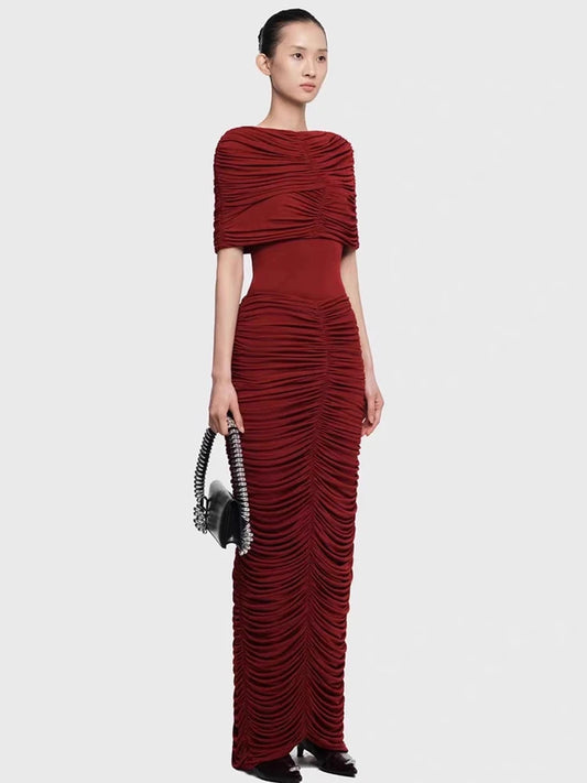 Straight-on silhouette shot emphasizing the sculpted drape and gathered detailing from bodice to skirt, styled for a formal evening.