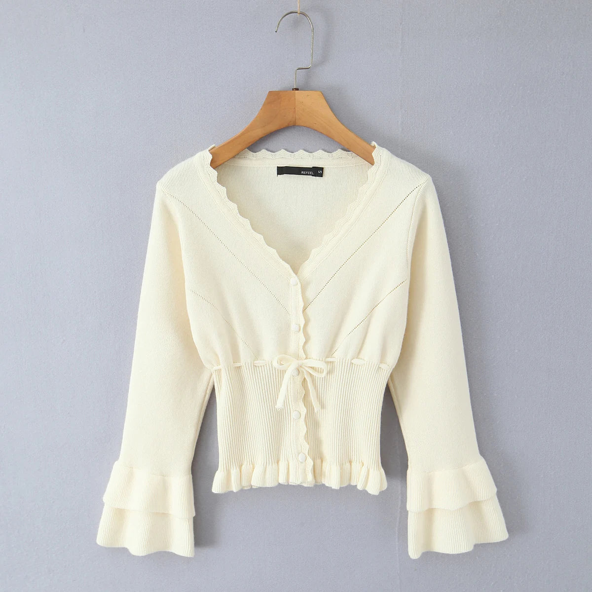 Apricot lace-up cropped knit cardigan styled for spring layering