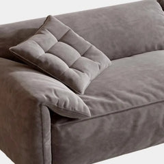 “Side view of cream wind couch showing plush armrest and sleek shape”

