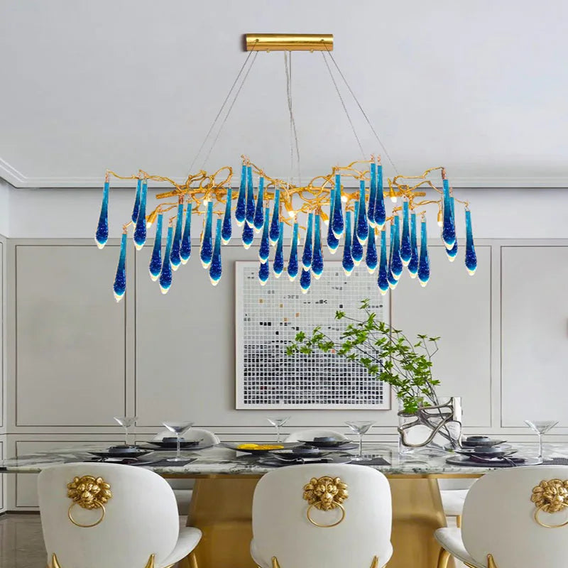 Artistic blue crystal pendant adds sculptural glam to a contemporary dining room