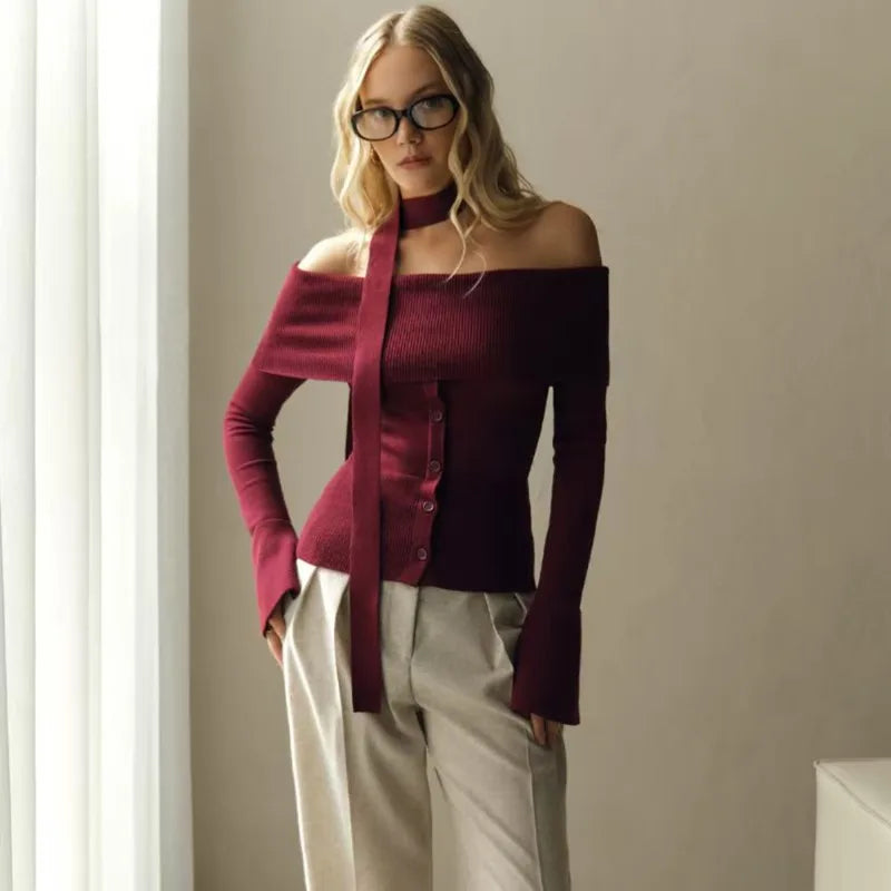 A close-up shot of the scarf ribbon and the sleek knit fabric texture.

