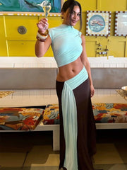 Close-up of asymmetric draping and cutout on maxi dress
