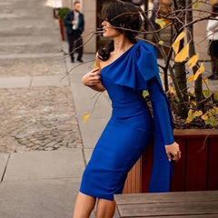 asymmetrical bodycon blue sleeve dress styled for winter cocktails