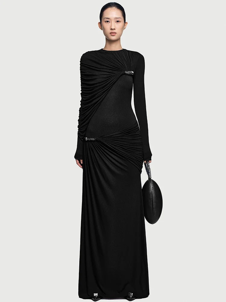 Close-up of the asymmetrical drape across the chest, showing gathered ruching and a sculpted shoulder line with a refined finish.