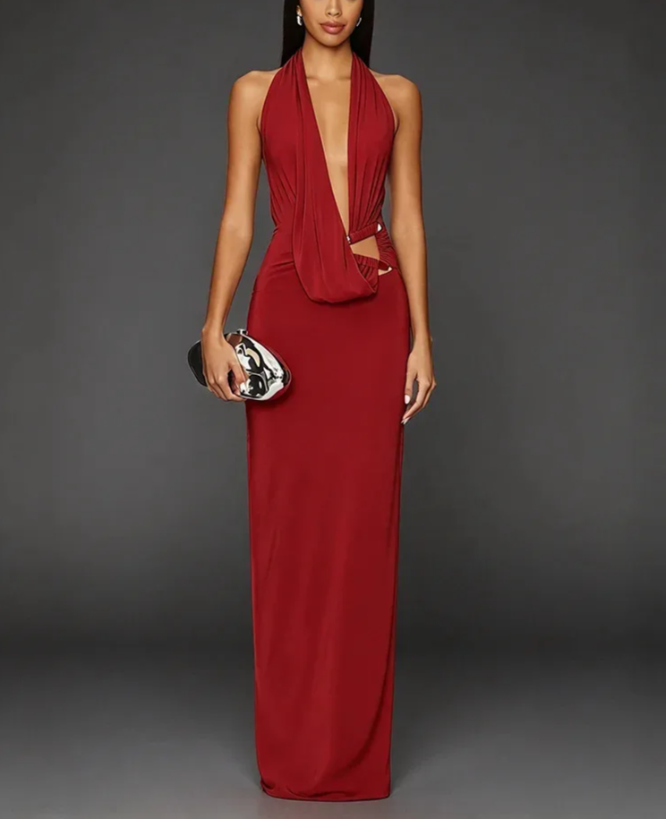 Model wearing a red halter neck cutout maxi dress with a clutch