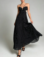 Black polka dot maxi dress with strappy neckline and side cutouts