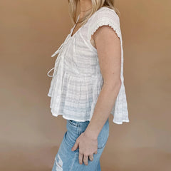 A full-length shot of the babydoll blouse, styled for a summer outing.