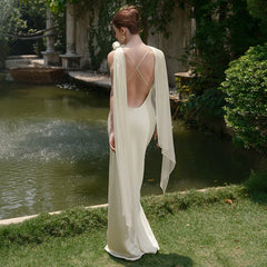 Back view of apricot satin dress styled for outdoor formal event