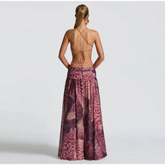 Back view of a woman wearing a patterned dress cutout maxi dress perfect for resort events with a backless design on a white background.