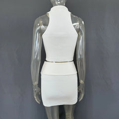 Back view of mannequin wearing a white knit set showing a fitted silhouette and a clean finish grey background.