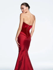 Red evening gown with open back on a white background