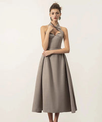 A close-up shot of the halter neckline and the high-waist detail on the dress.