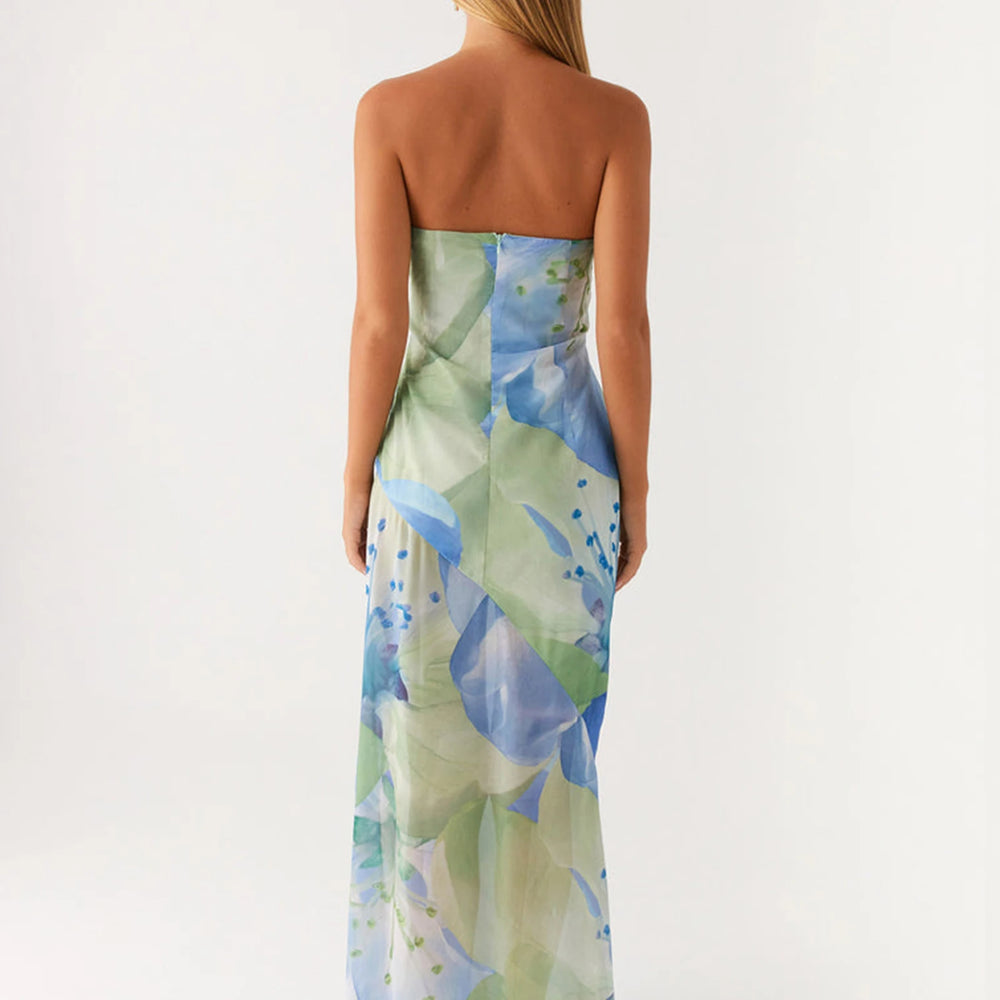 Woman wearing a strapless dress with a floral pattern on a white background backless view of sundress