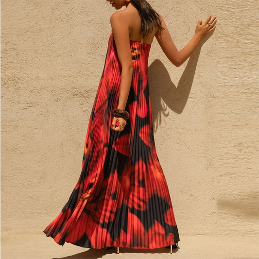 Woman wearing a backless strapless maxi styled for vacation dinners against a beige wall