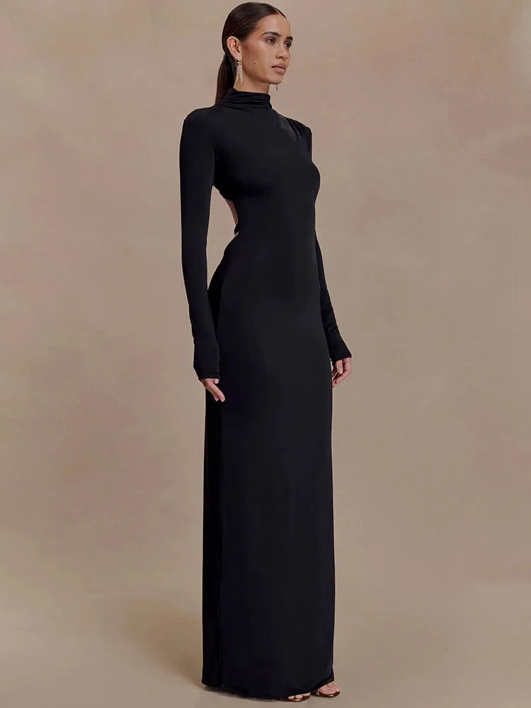 Back view of black turtleneck cut-out maxi dress showing sculpted open back