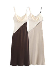 Backless detail of the satin maxi dress in beige and ivory tones