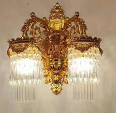 Baroque gold crystal wall sconce with ornate detailing and tiered pendants