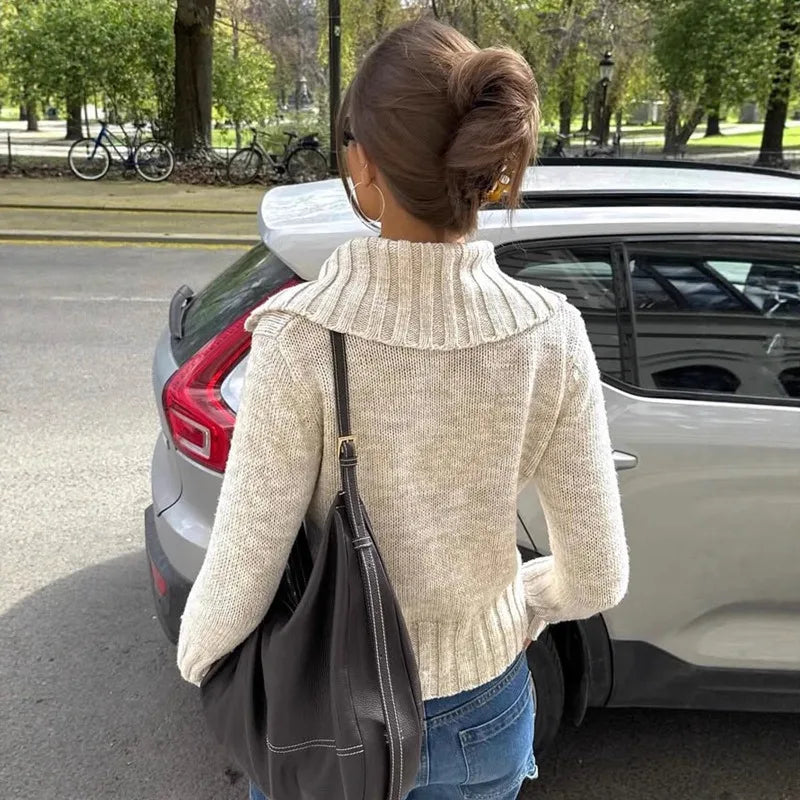 The full length of the knit top, highlighting its flattering silhouette.