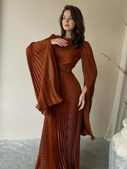 A close-up shot of the batwing sleeve and the lace-up detail on the dress.

