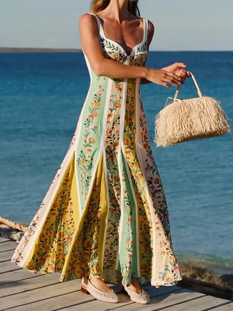 Woman in a  spaghetti-strap maxi dress styled for a coastal walk, holding a straw bag by the ocean