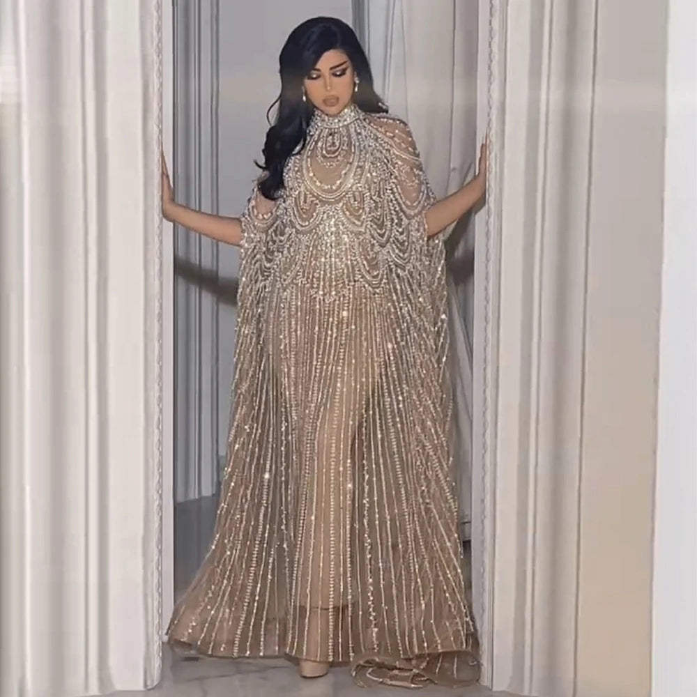 Woman in a sparkling gold dress standing in a doorway.