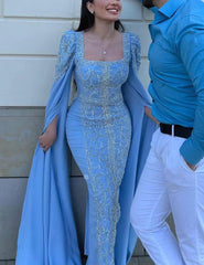 A full-length shot of the beaded evening dress, highlighting the elegant cape sleeves.