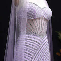 Elegant beaded luxury wedding formal cape gown displayed for elegant occasions, with intricate detailing on a black background