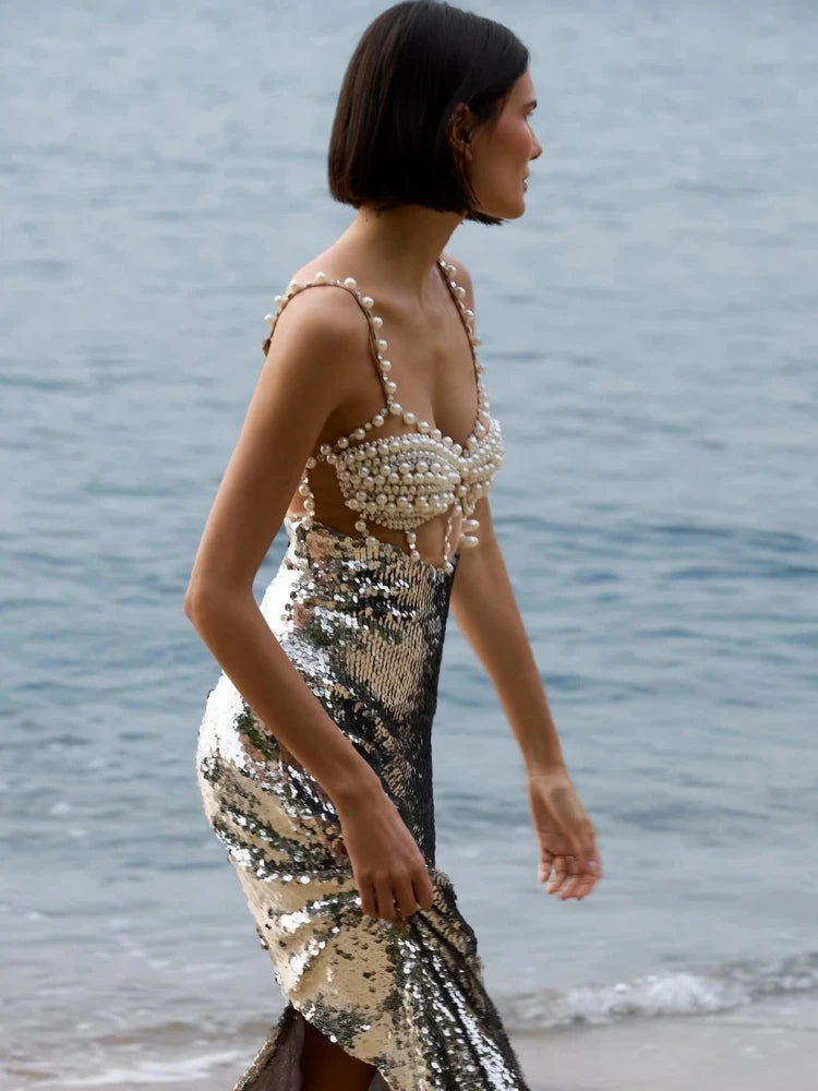 Side view of the silver midi dress capturing the slim sheath silhouette and smooth drape.