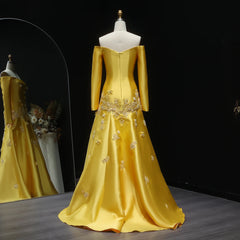 Yellow beaded trumpet skirt evening dress for women’s gala occasions on a mannequin against a dark background.