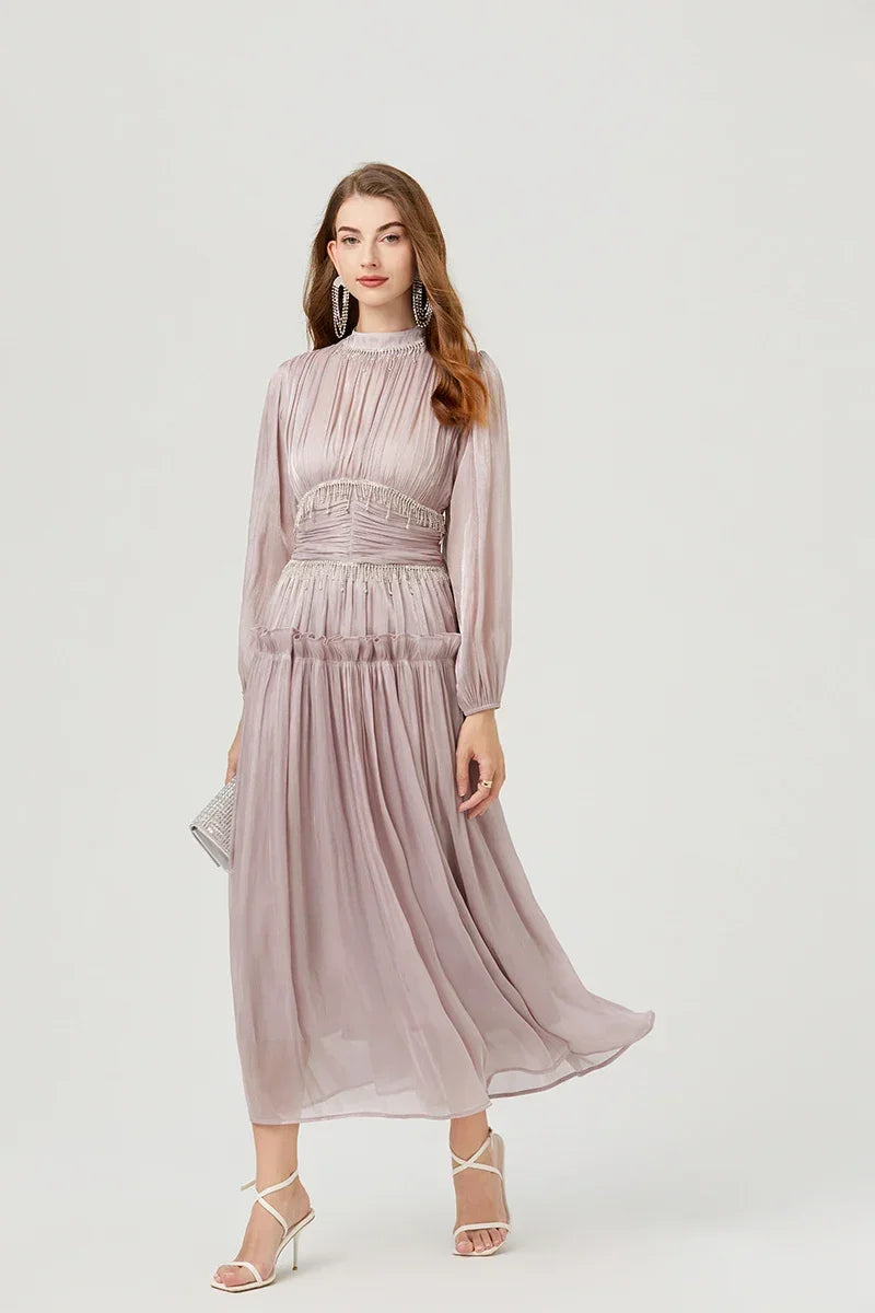 Close-up of the beaded waist detail and gathered chiffon pleats, showing subtle shimmer and texture across the bodice and waistband.