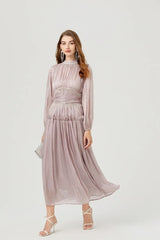 Close-up of the beaded waist detail and gathered chiffon pleats, showing subtle shimmer and texture across the bodice and waistband.