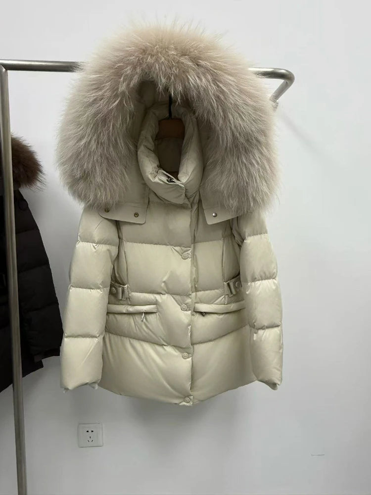 Beige puffer coat with a large natural raccoon fur hood on a hanger.