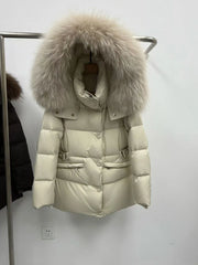 Beige puffer coat with a large natural raccoon fur hood on a hanger.