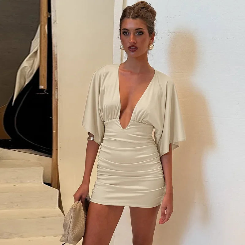Beige ruched v-neck mini dress styled for autumn parties