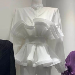 White dress on a mannequin against a plain background