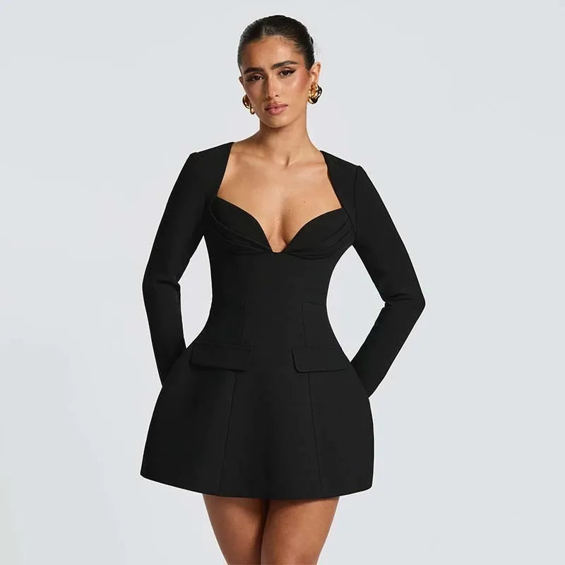 Black a-line mini dress styled for night out with deep neckline