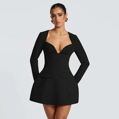 Black a-line mini dress styled for night out with deep neckline
