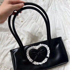 Vintage-inspired black handbag with lace heart detail