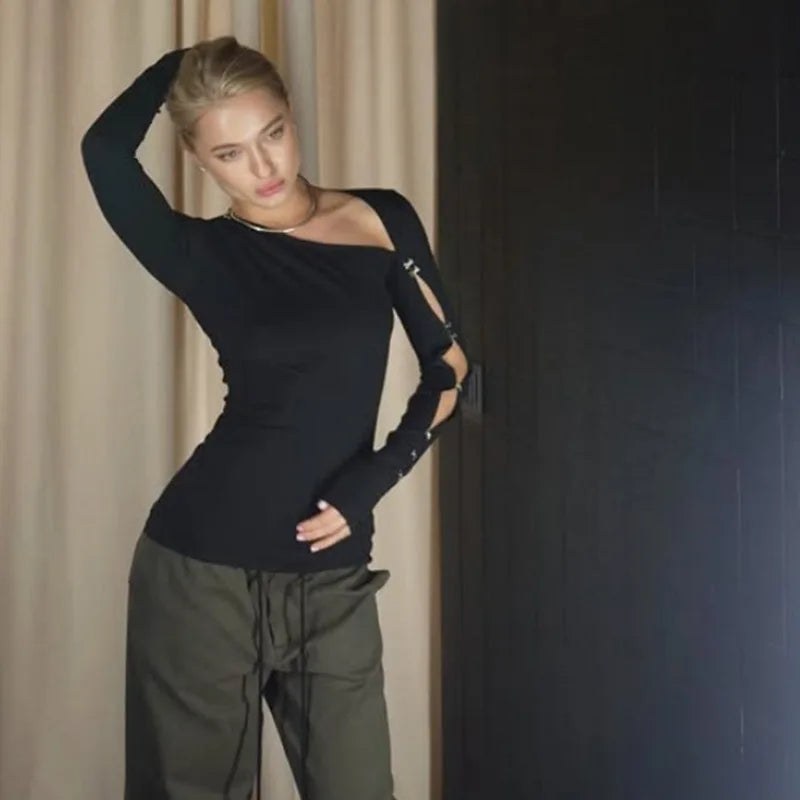 Waist-up angle of a black asymmetric top showing clean drape through the torso and the neckline’s sharp, angled finish.