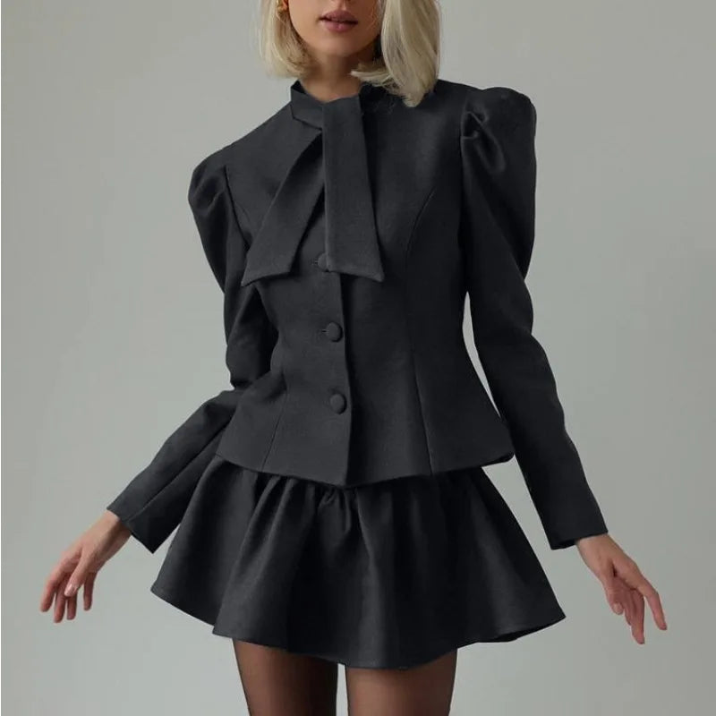 Black blazer and pleated mini skirt set styled for women