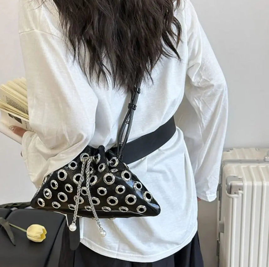 Top view highlighting the drawstring opening, sturdy handle, and chain detail gathered at the center for a sharper look.