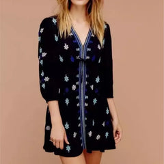 Black embroidered mini dress styled for boho streetwear