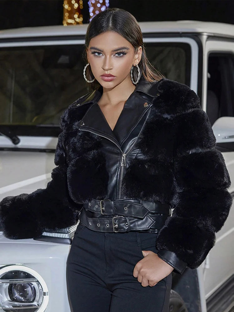 Woman wearing a black fur coat standing next to a vehicle